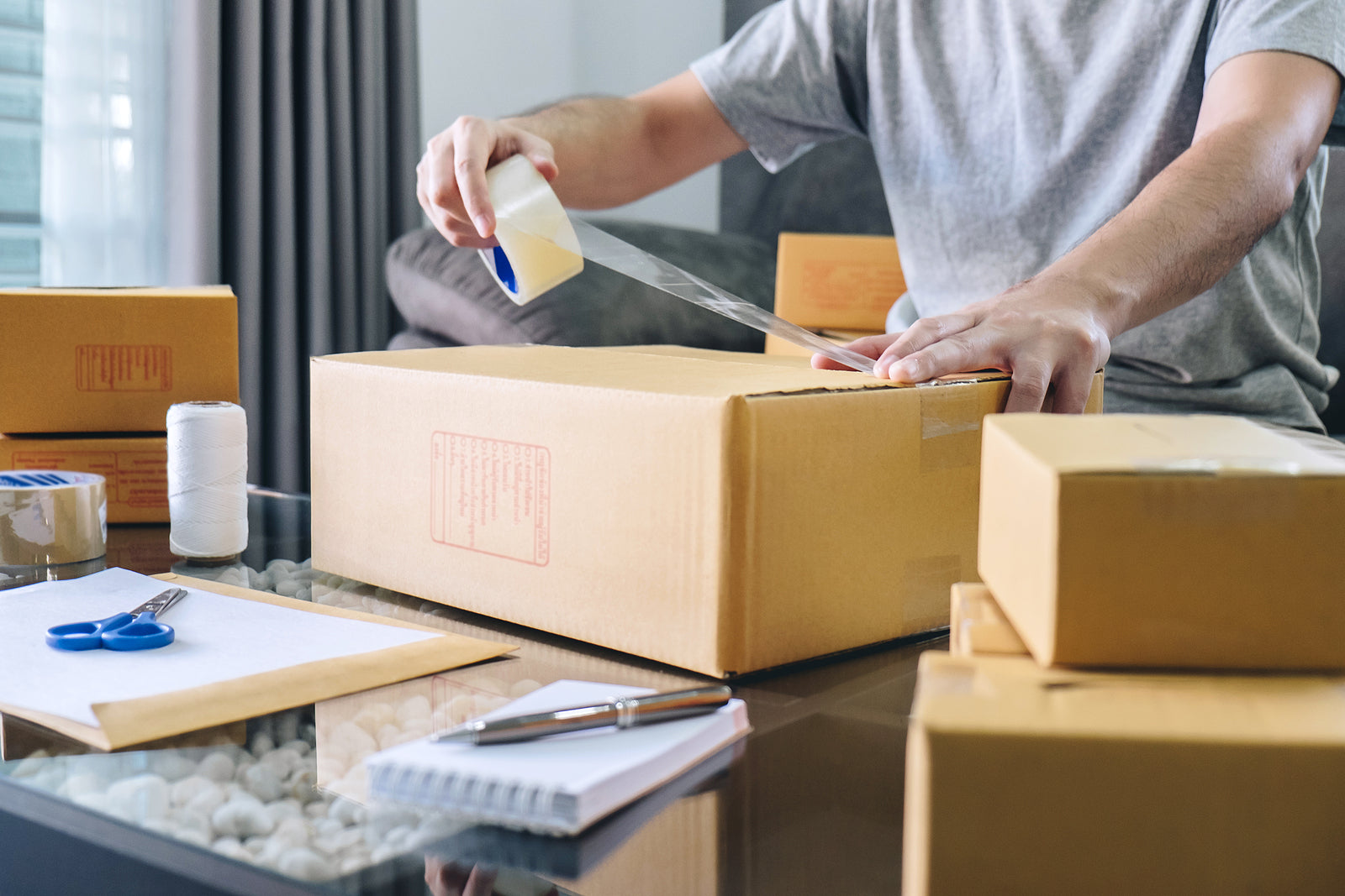 Eco friendly postal boxes - man working with packaging